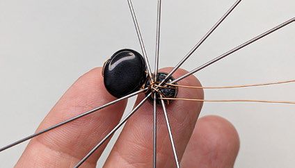 Wires protrude from the back of the ornament frame